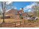 A spacious backyard featuring a deck, mature trees, and a privacy fence at 226 Double Gate Ct, Sugar Hill, GA 30518