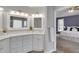 Well-appointed bathroom featuring dual sinks, quartz countertops, and a view into the primary bedroom at 226 Double Gate Ct, Sugar Hill, GA 30518