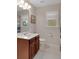 Bright bathroom featuring a white vanity, toilet, and a window for natural light at 226 Double Gate Ct, Sugar Hill, GA 30518