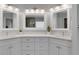 Bright bathroom featuring dual sinks, quartz countertops, and a modern design at 226 Double Gate Ct, Sugar Hill, GA 30518