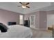 Inviting bedroom with a plush bed, ceiling fan, and neutral color palette for a calming ambiance at 226 Double Gate Ct, Sugar Hill, GA 30518