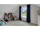 Upstairs bonus room featuring a blue curtained window and multiple stuffed animals at 226 Double Gate Ct, Sugar Hill, GA 30518