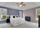 Comfortable primary bedroom with a cozy bed and bright natural light from the large windows at 226 Double Gate Ct, Sugar Hill, GA 30518