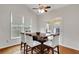 Cozy breakfast nook features hardwood floors, wainscoting, and a table set for four at 226 Double Gate Ct, Sugar Hill, GA 30518