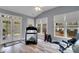 Bright exercise room with a treadmill, weights, and floor to ceiling windows at 226 Double Gate Ct, Sugar Hill, GA 30518