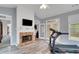 Bright exercise room featuring a brick fireplace and modern exercise equipment at 226 Double Gate Ct, Sugar Hill, GA 30518
