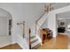 Bright foyer featuring hardwood floors, piano, and staircase at 226 Double Gate Ct, Sugar Hill, GA 30518