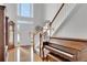 Bright foyer featuring hardwood floors, piano, staircase, and an abundance of natural light at 226 Double Gate Ct, Sugar Hill, GA 30518