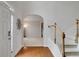 Bright foyer featuring hardwood floors, stairs, and an arched doorway at 226 Double Gate Ct, Sugar Hill, GA 30518