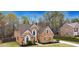 Charming two-story brick home with a manicured front lawn and garden at 226 Double Gate Ct, Sugar Hill, GA 30518