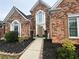 Charming brick home featuring a well-manicured lawn and a walkway to the front door at 226 Double Gate Ct, Sugar Hill, GA 30518