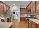 Kitchen with stainless steel appliances, wood cabinets, and adjacent breakfast nook at 226 Double Gate Ct, Sugar Hill, GA 30518