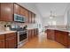 Kitchen with stainless steel appliances and rich wood cabinetry at 226 Double Gate Ct, Sugar Hill, GA 30518