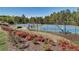 Scenic view of the tennis courts with surrounding greenery and blooming flowers at 226 Double Gate Ct, Sugar Hill, GA 30518