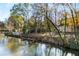 Picturesque water view of home with landscaped yard and gazebo at 1840 Brandon Hall Dr, Atlanta, GA 30350