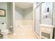 This bathroom features a bathtub, glass-doored shower, toilet, and a tiled floor at 225 E Ponce De Leon Ave # 317, Decatur, GA 30030