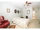 Comfortable bedroom with floral bedding, a ceiling fan, and a view into an adjacent bathroom at 225 E Ponce De Leon Ave # 317, Decatur, GA 30030