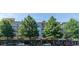 Attractive, low-rise building with street-level retail and lush mature trees lining the facade at 225 E Ponce De Leon Ave # 317, Decatur, GA 30030