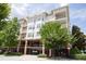 Well-maintained building exterior with balconies and lush trees at 225 E Ponce De Leon Ave # 317, Decatur, GA 30030