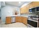 Efficient kitchen featuring stainless steel appliances, wood cabinets, and an open view to the dining area at 225 E Ponce De Leon Ave # 317, Decatur, GA 30030