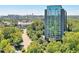 An aerial view of a modern high-rise condominium building with lush green trees at 3300 Windy Ridge Se Pkwy # 612, Atlanta, GA 30339