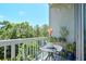 Outdoor balcony with a table, chair, and a view of lush trees under a blue sky at 3300 Windy Ridge Se Pkwy # 612, Atlanta, GA 30339