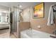 Modern bathroom with a soaking tub, glass-enclosed shower, and neutral tile at 3300 Windy Ridge Se Pkwy # 612, Atlanta, GA 30339