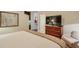 Bright bedroom showcases a large dresser, seating area, and view of a partial kitchen area in the background at 3300 Windy Ridge Se Pkwy # 612, Atlanta, GA 30339