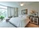Bright bedroom featuring a large window, neutral colors, and comfortable furnishings at 3300 Windy Ridge Se Pkwy # 612, Atlanta, GA 30339