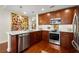 Modern kitchen with custom cabinetry, stainless steel appliances, and white countertops with a view into the dining area at 3300 Windy Ridge Se Pkwy # 612, Atlanta, GA 30339