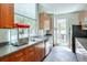 Bright kitchen featuring modern appliances, gray countertops, and ample natural light from a large window at 3300 Windy Ridge Se Pkwy # 612, Atlanta, GA 30339