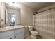 Well-lit bathroom features a granite countertop vanity and shower with curtain at 2461 Bayrose Cir, Atlanta, GA 30344