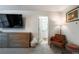 Bedroom with view to en suite bathroom, tv, dresser, chair, and decor at 2461 Bayrose Cir, Atlanta, GA 30344