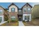 Charming two-story townhome with a mix of brick and siding, offering a welcoming front entrance at 2461 Bayrose Cir, Atlanta, GA 30344