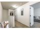 Upstairs hallway with carpet and neutral paint, featuring an open doorway to a living room area at 2461 Bayrose Cir, Atlanta, GA 30344