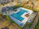 Aerial view showcases a large community pool, pergola, and lounge area with trees and manicured landscaping at 2461 Bayrose Cir, Atlanta, GA 30344