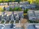 Aerial view of newly constructed townhomes with manicured lawns, sidewalks, and ample parking at 2461 Bayrose Cir, Atlanta, GA 30344
