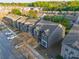 Aerial view features neatly arranged townhomes with well-maintained lawns, sidewalks, and street parking at 2461 Bayrose Cir, Atlanta, GA 30344