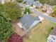 An aerial view of a gray home with a dark roof, green backyard, and small patio at 3227 Grove Trl, Acworth, GA 30101