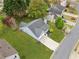 Aerial view of a well-maintained home with a spacious yard, long driveway, and established landscaping at 3227 Grove Trl, Acworth, GA 30101