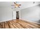 Bright bedroom with vaulted ceiling, fan, and wood-styled vinyl flooring at 3227 Grove Trl, Acworth, GA 30101