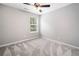 Cozy bedroom with carpet, fan, and a window letting in natural light at 3227 Grove Trl, Acworth, GA 30101