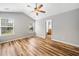 Bedroom with vaulted ceiling, two windows, ceiling fan, and wood-styled vinyl flooring at 3227 Grove Trl, Acworth, GA 30101