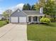 Charming single-Gathering home featuring a well-manicured lawn, two-car garage, and a welcoming front porch at 3227 Grove Trl, Acworth, GA 30101