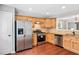 Well-lit kitchen features stainless steel appliances, granite counters, wood cabinets, and modern lighting at 3227 Grove Trl, Acworth, GA 30101