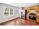 Kitchen features wood cabinets, stainless steel appliances, granite countertops, and natural light at 3227 Grove Trl, Acworth, GA 30101