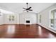Bright living room with hardwood floors, a vaulted ceiling, fireplace, and ample natural light at 3227 Grove Trl, Acworth, GA 30101