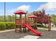 Community playground with a red slide and other equipment on a rubber surface at 3227 Grove Trl, Acworth, GA 30101