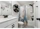 Clean bathroom featuring a vanity with white countertop and tub with shower at 3628 Silvery Way, Powder Springs, GA 30127