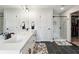 Modern bathroom with dual sinks, a glass-enclosed shower, and a walk-in closet for added convenience at 3628 Silvery Way, Powder Springs, GA 30127